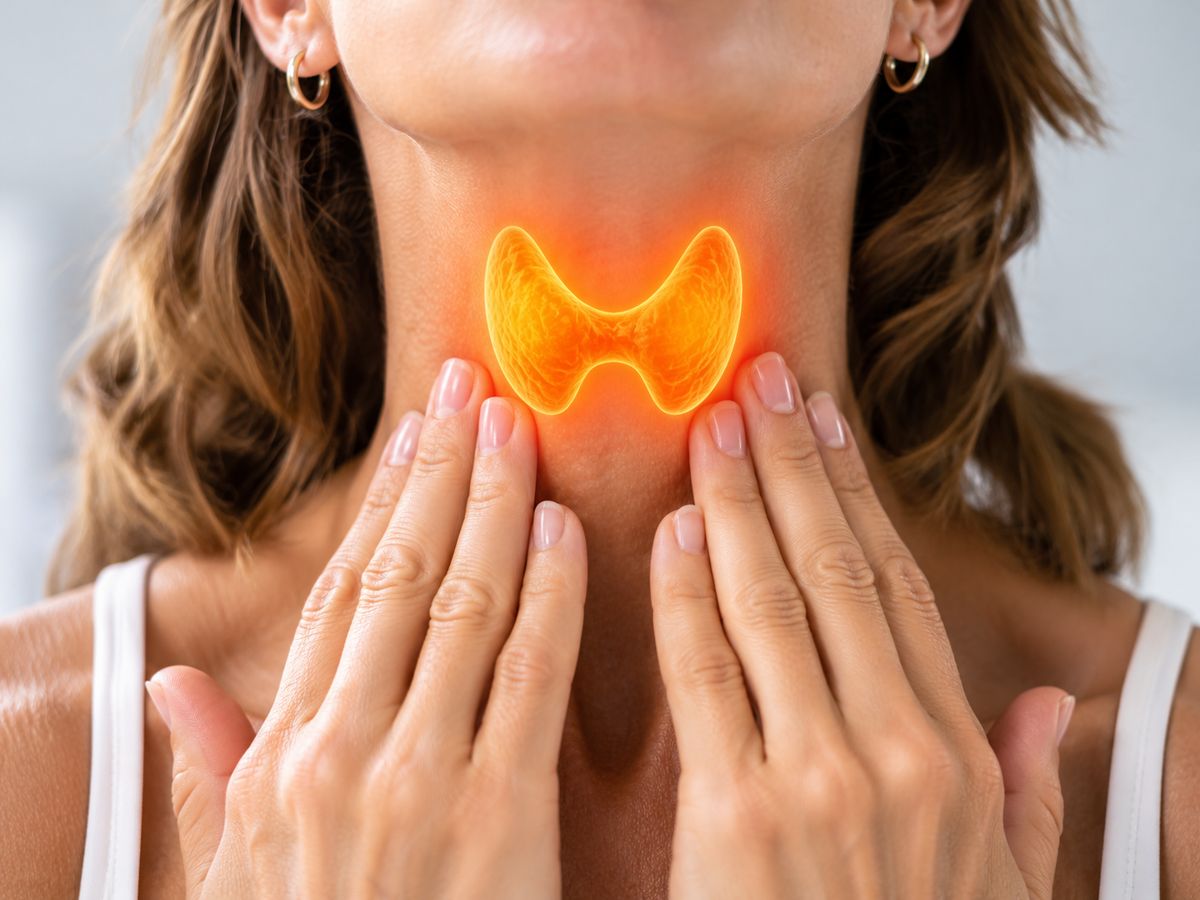 A person touching the neck over a highlighted thyroid